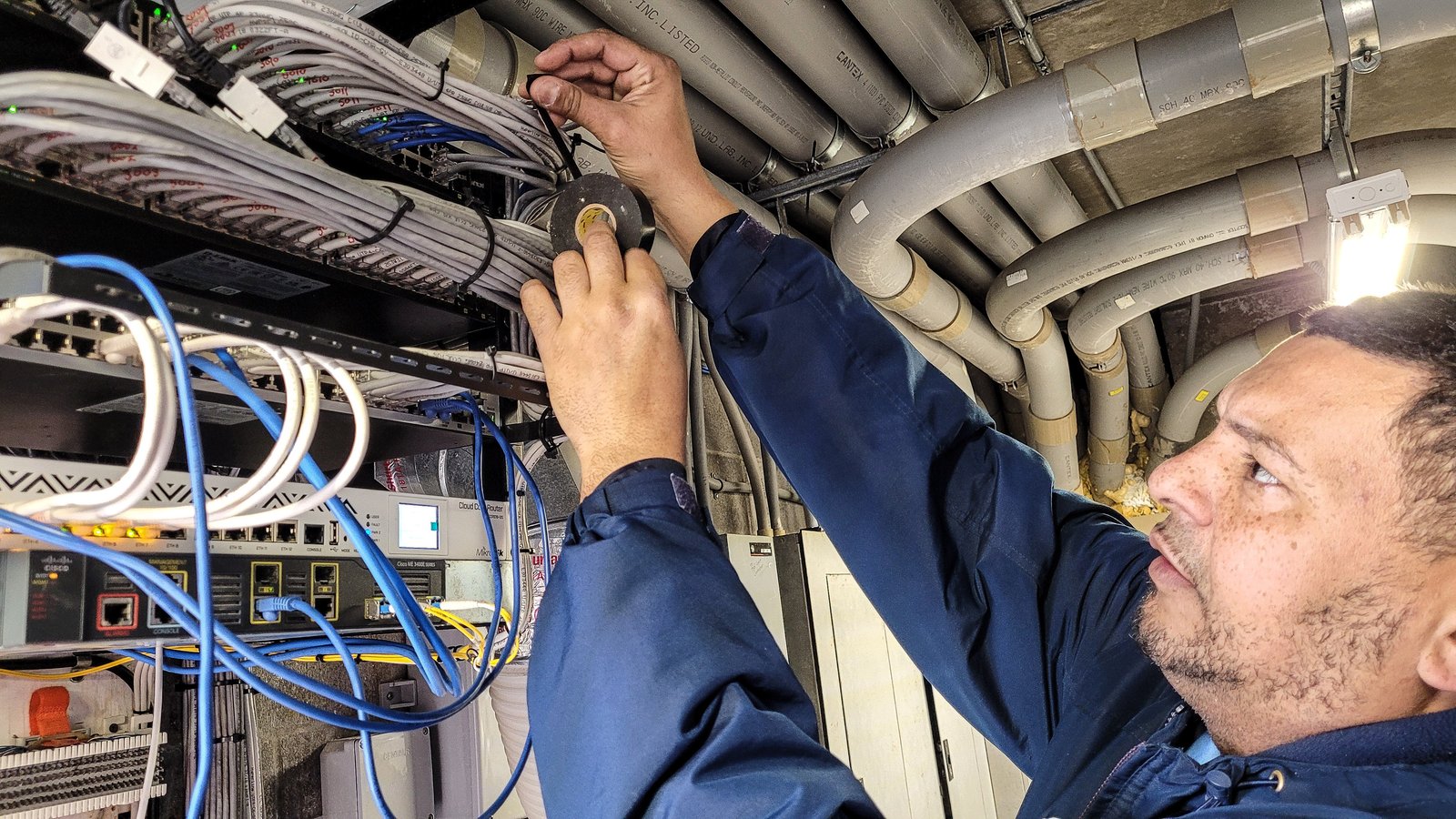 A technician connecting network cabling