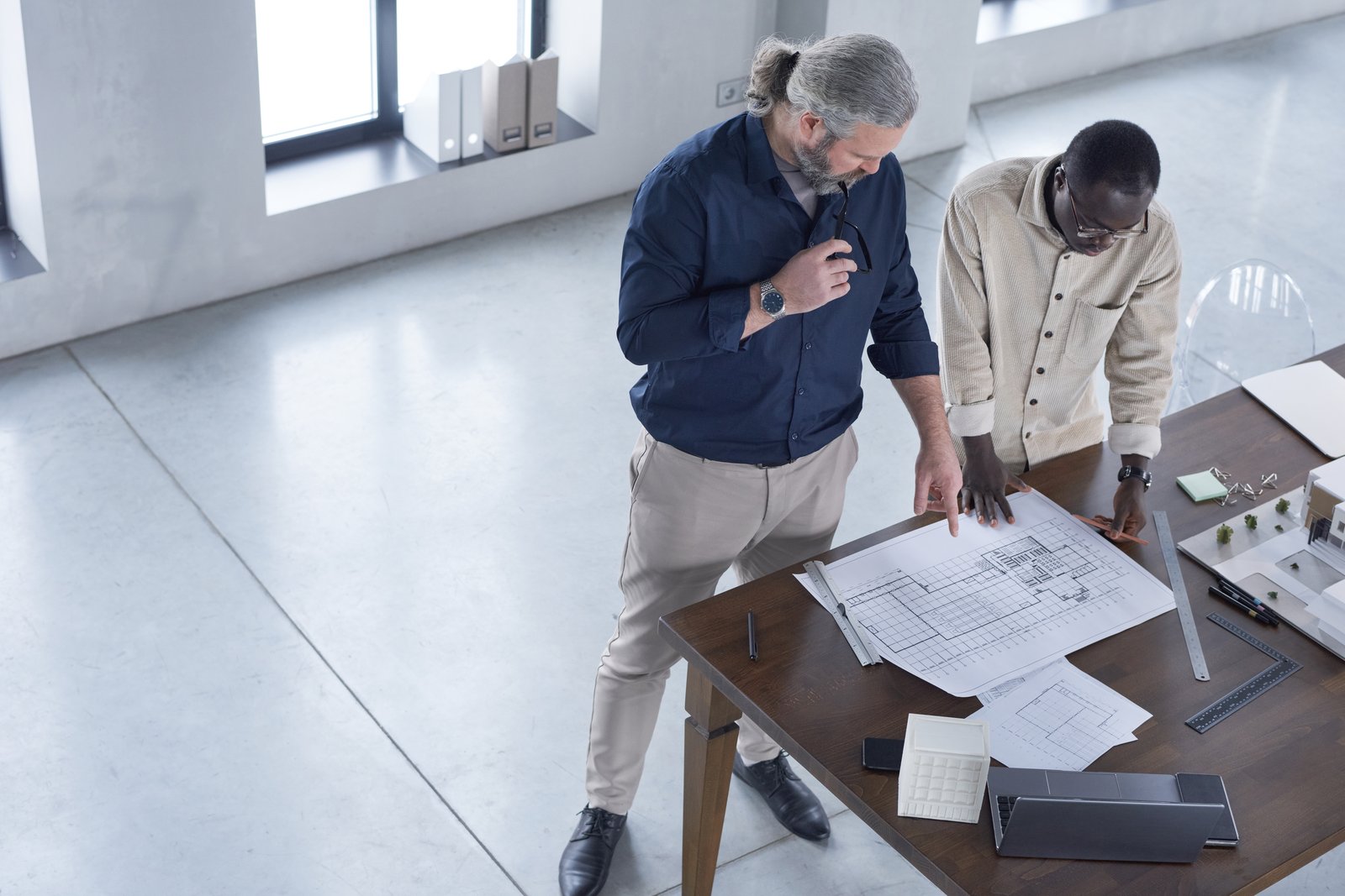 Engineers reviewing drawings at a worktable